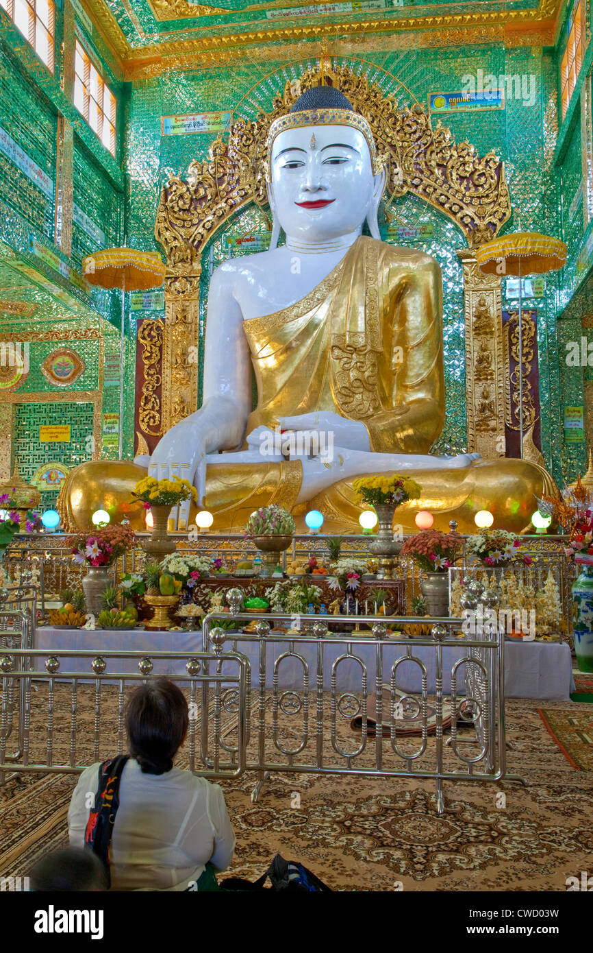 Myanmar, Burma. Buddha Statue and Worshiper, near Mandalay. Soon U Ponya Shin Pagoda, Sagaing Hill. Stock Photo