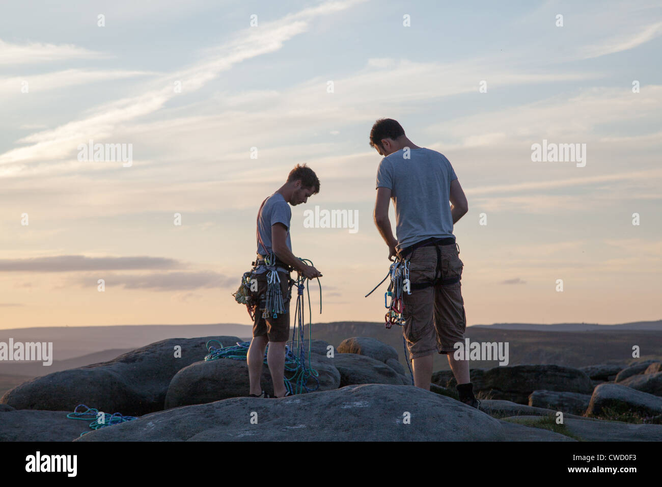 Stanage Top Rope Two climbers on Stanage Edge, Derbyshire, coiling their ropes at the ...