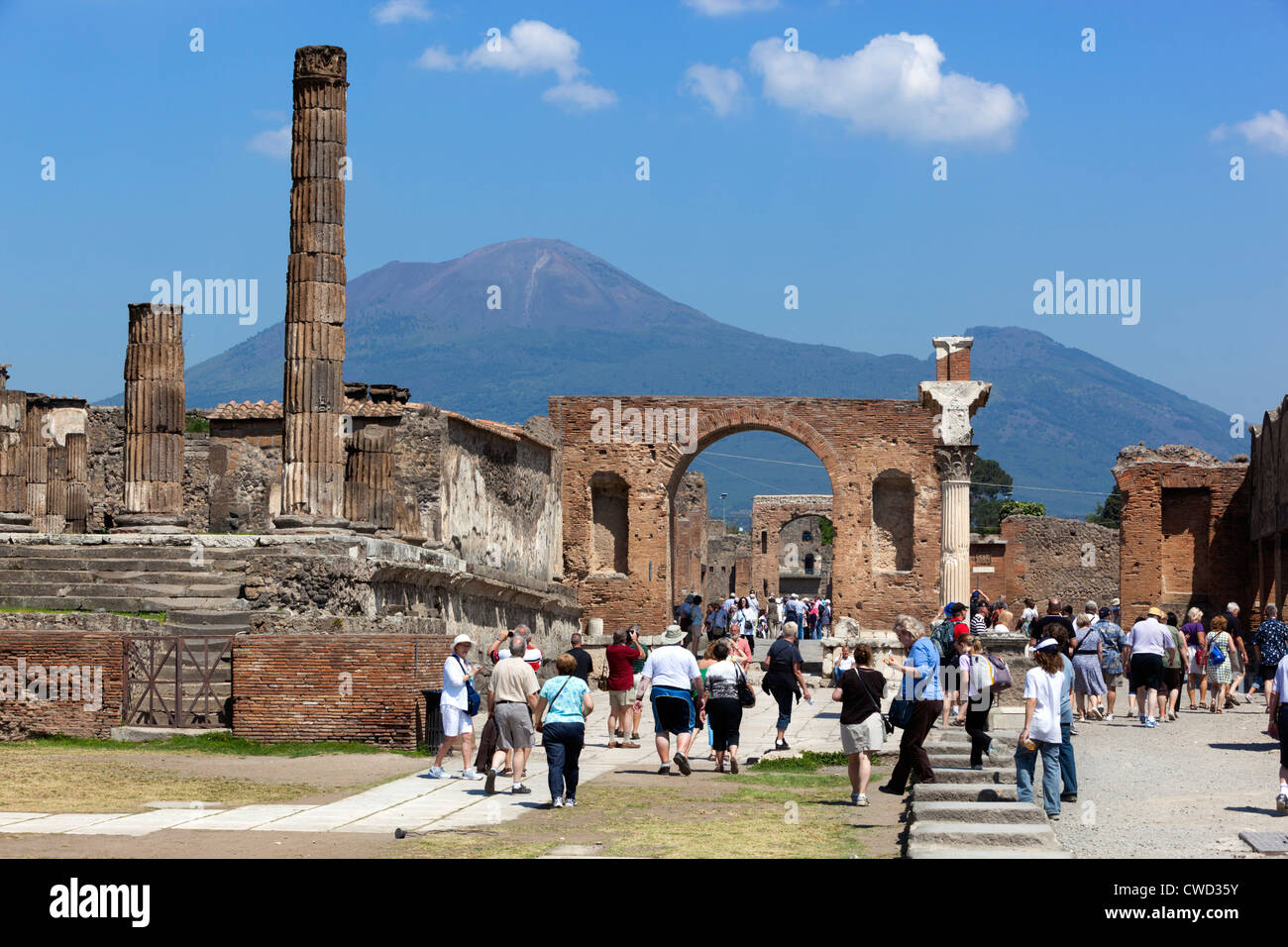Roman forum ruins busy with tourists and Mount Vesuvius behind Stock Photo