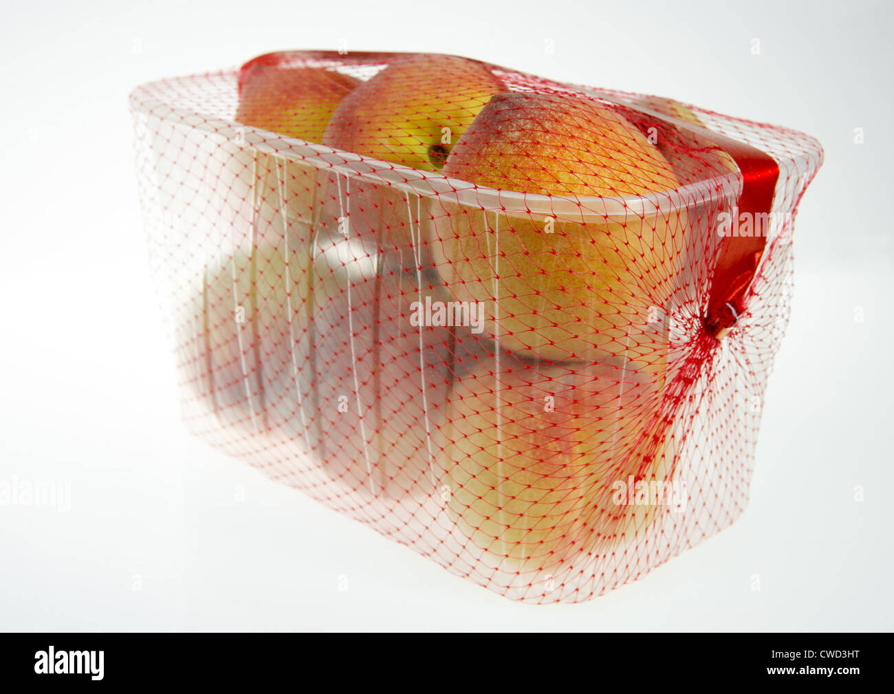 Spanish peaches in a plastic container frame covered by a red net Stock Photo Alamy