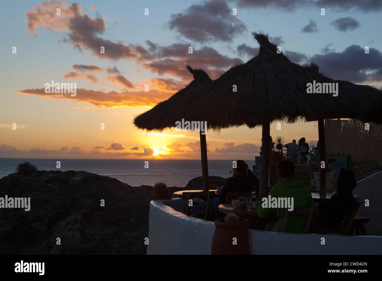 Sunset over cafe at Playa del Papagayo Stock Photo