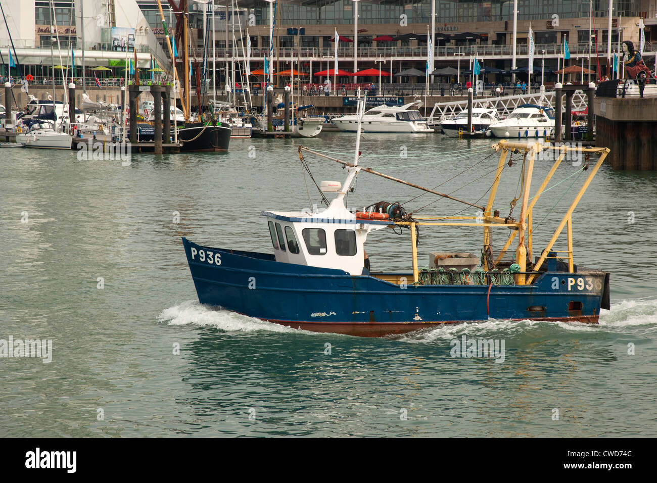 A fishing boat heads to the ocean from Portsmouth harbour, England