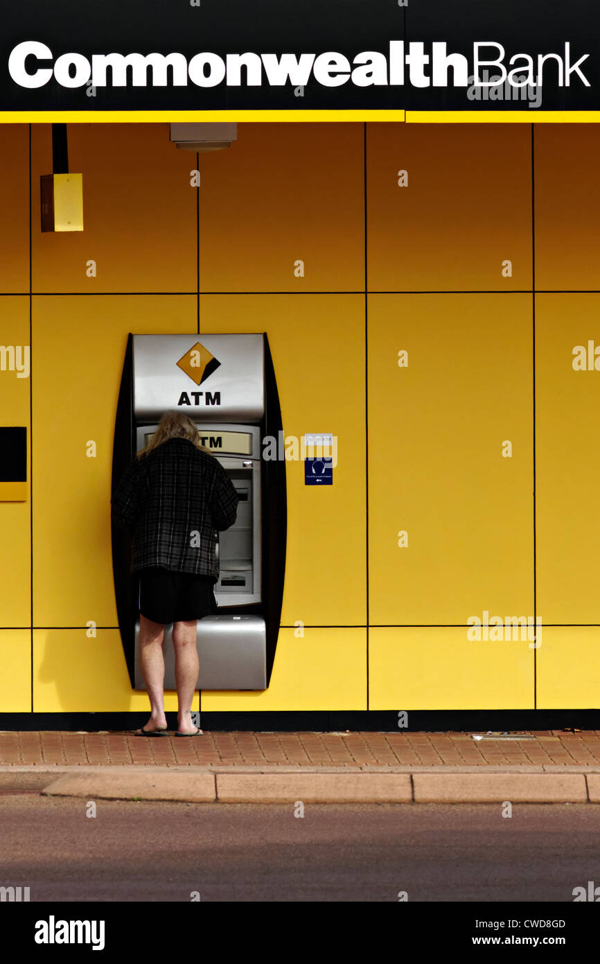 Person standing at a Australian Commonwealth Bank automat teller machine Stock Photo
