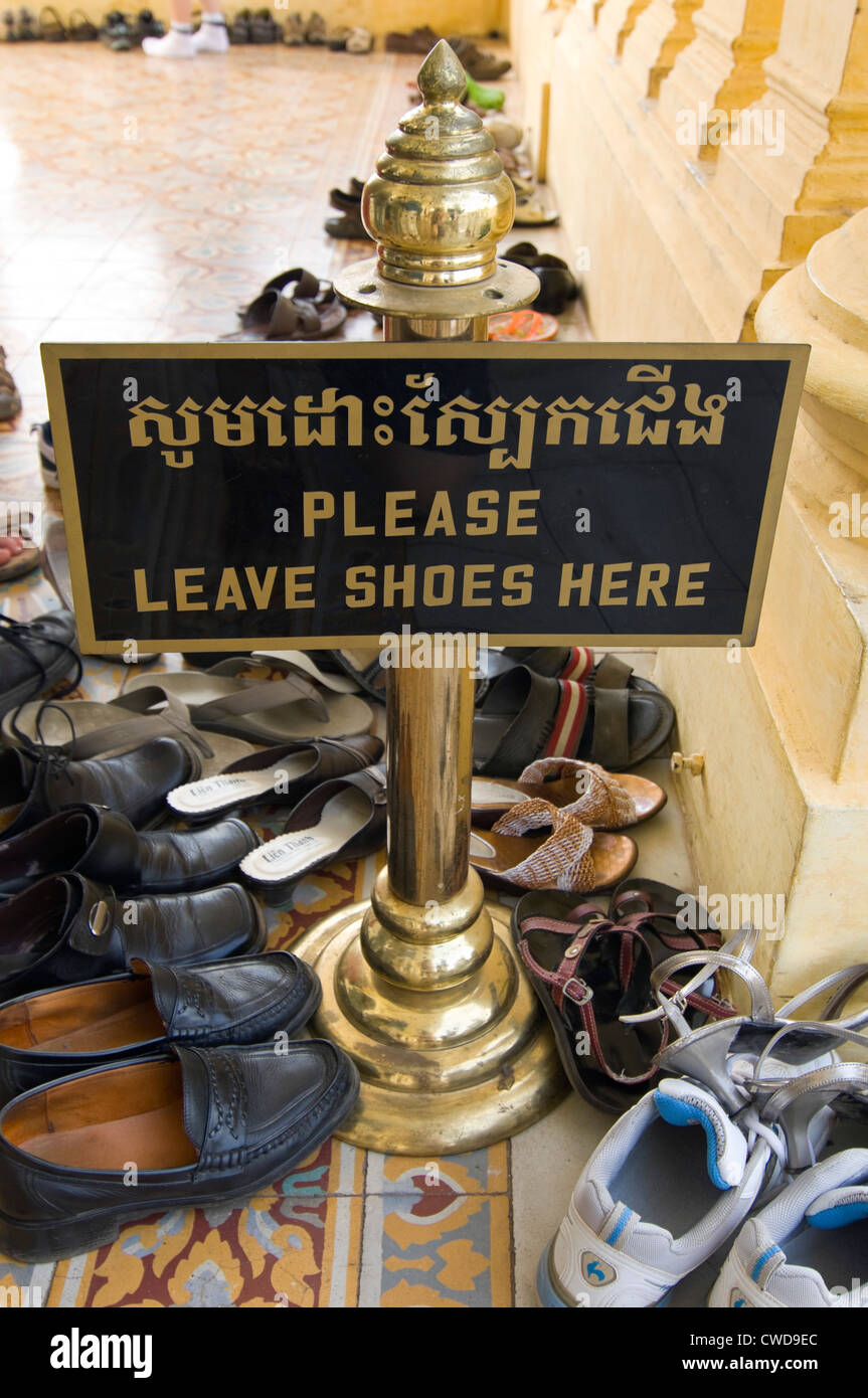 Vertical close up of lots of pairs of shoes removed to enter into the Royal Palace in Phnom Penh. Stock Photo