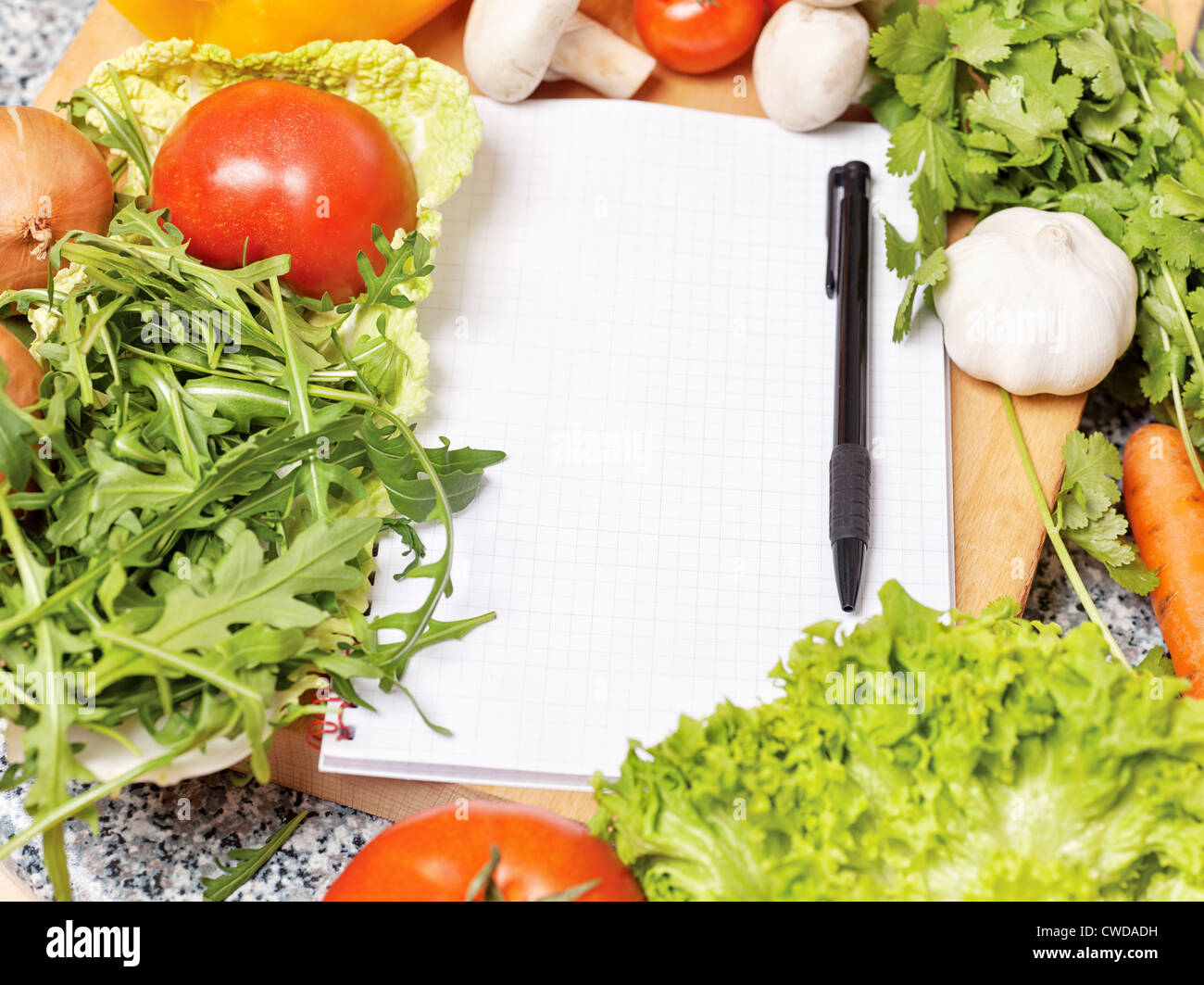 Note book among the vegetables for writing recipe Stock Photo