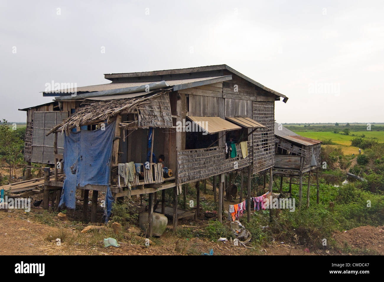 Horizontal wide angle view of a stilted house in Kompong Khleang, the floating village on Tonle Sap Lake in Cambodia Stock Photo
