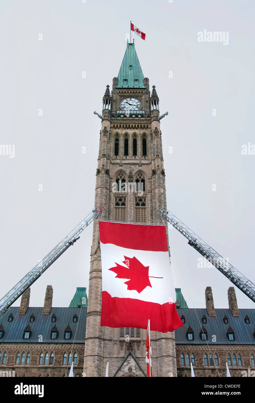 The Canadian Parliament Centre block with canadian flags during a celebration. Stock Photo
