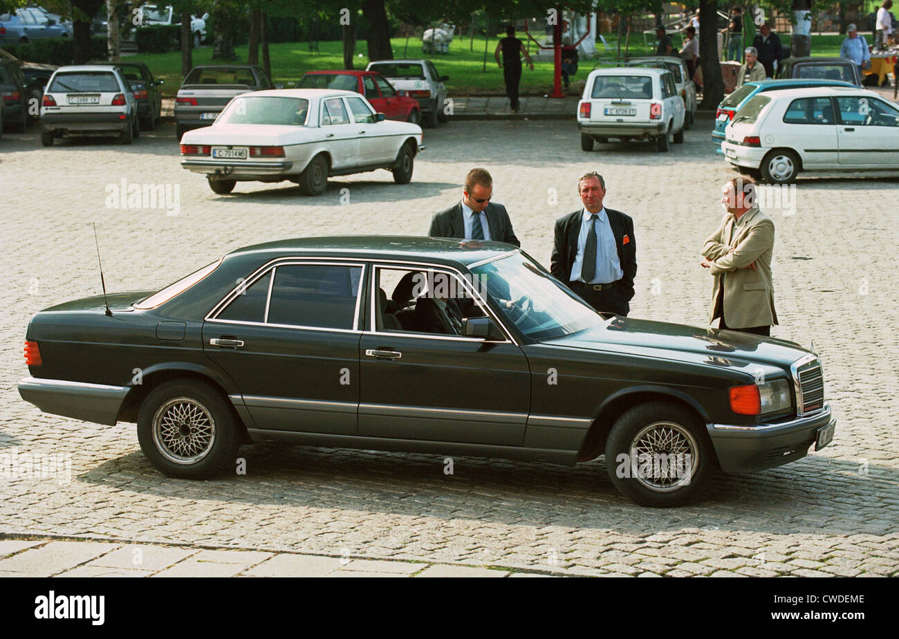 Driver and bodyguards wait a personality in their limousine, Sofia Stock Photo