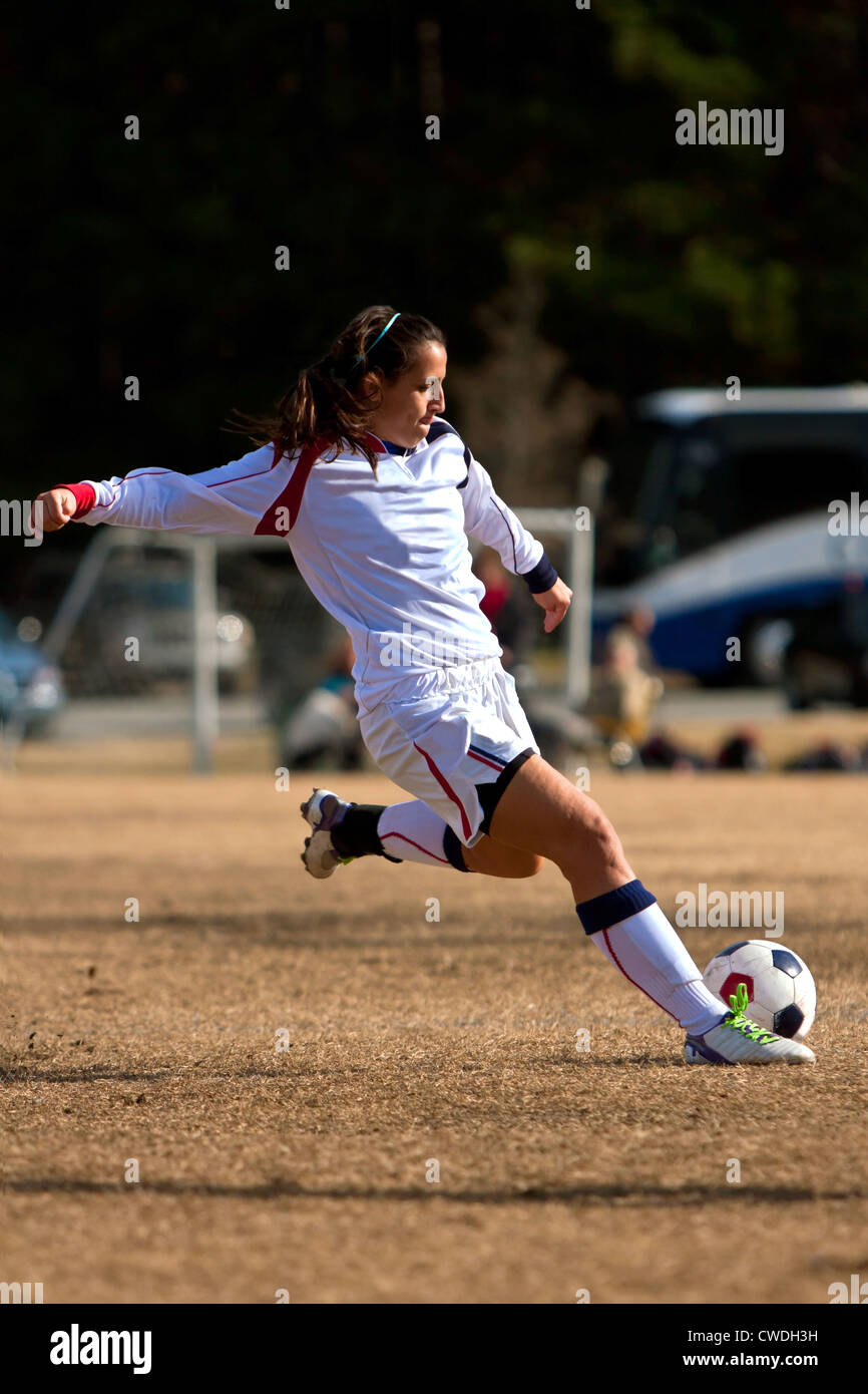 Female Soccer Player Winds Up To Kick Ball During Game Stock Photo Alamy