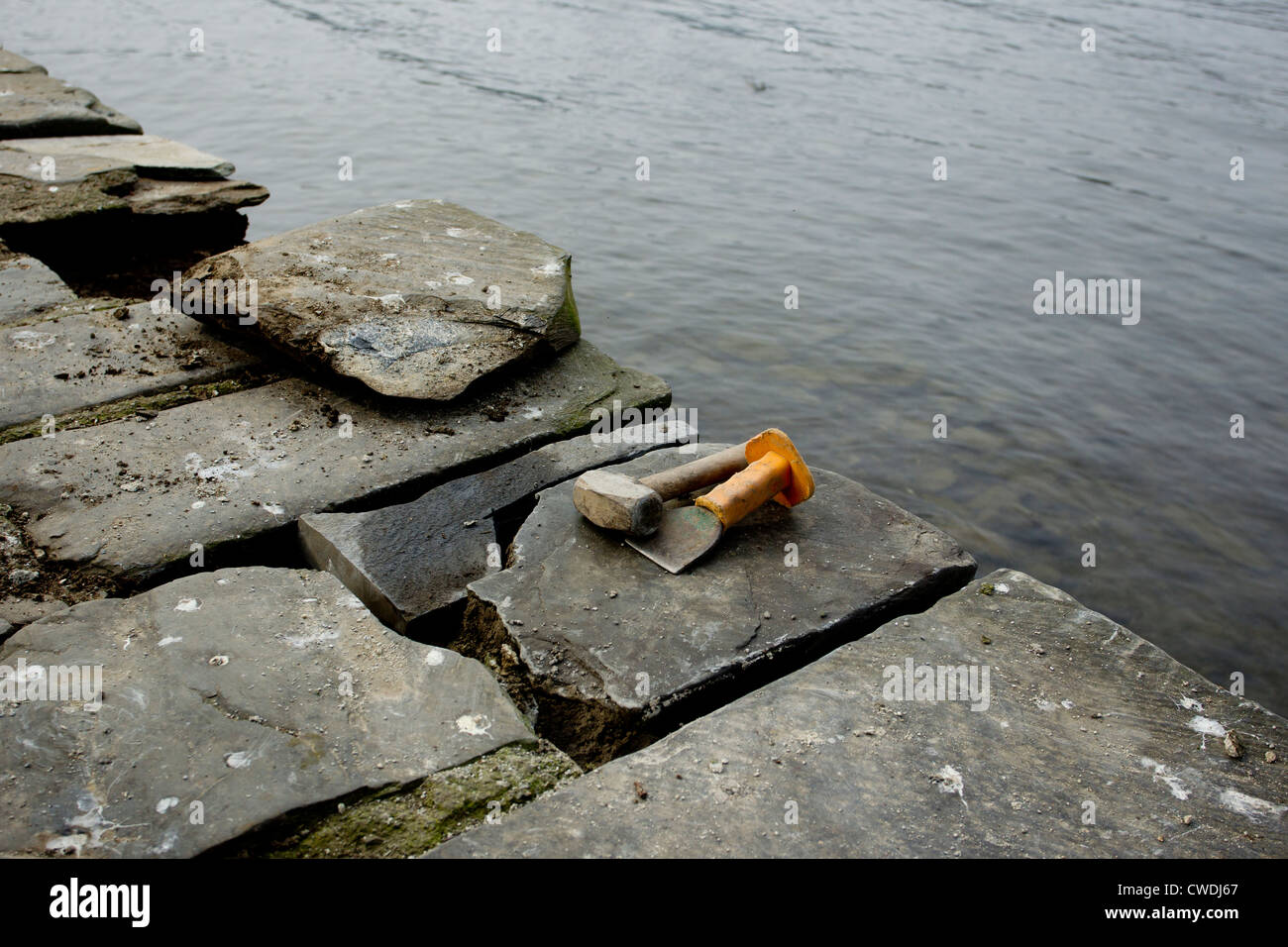 Repairs to Lakeland stone path on the edge of Lake Windermere Stock