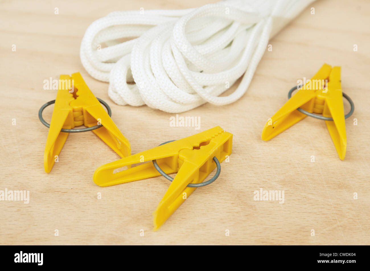Clothespins and clothesline on a wooden board, closeup Stock Photo Alamy