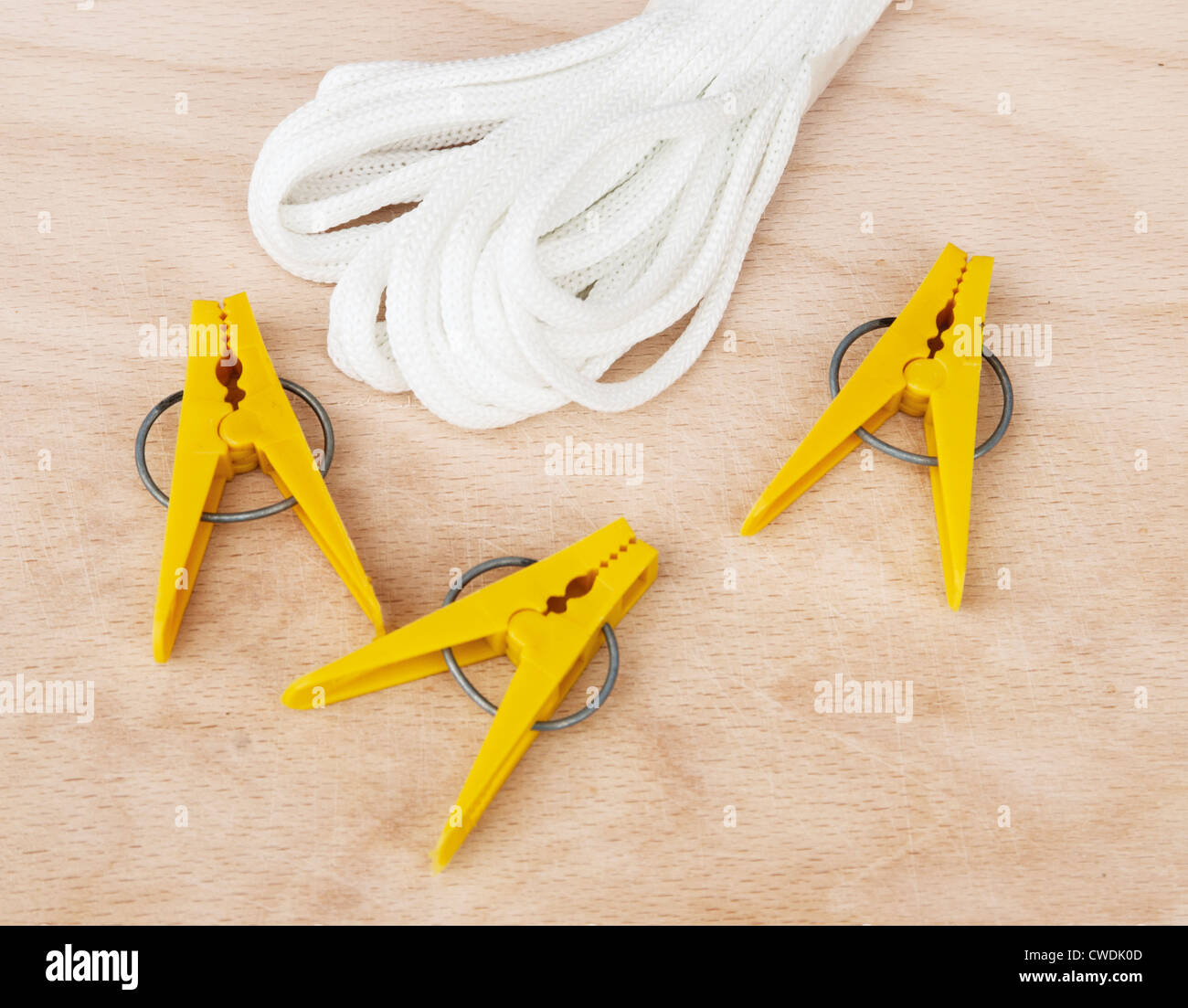 Clothespins and clothesline on a wooden board, closeup Stock Photo Alamy