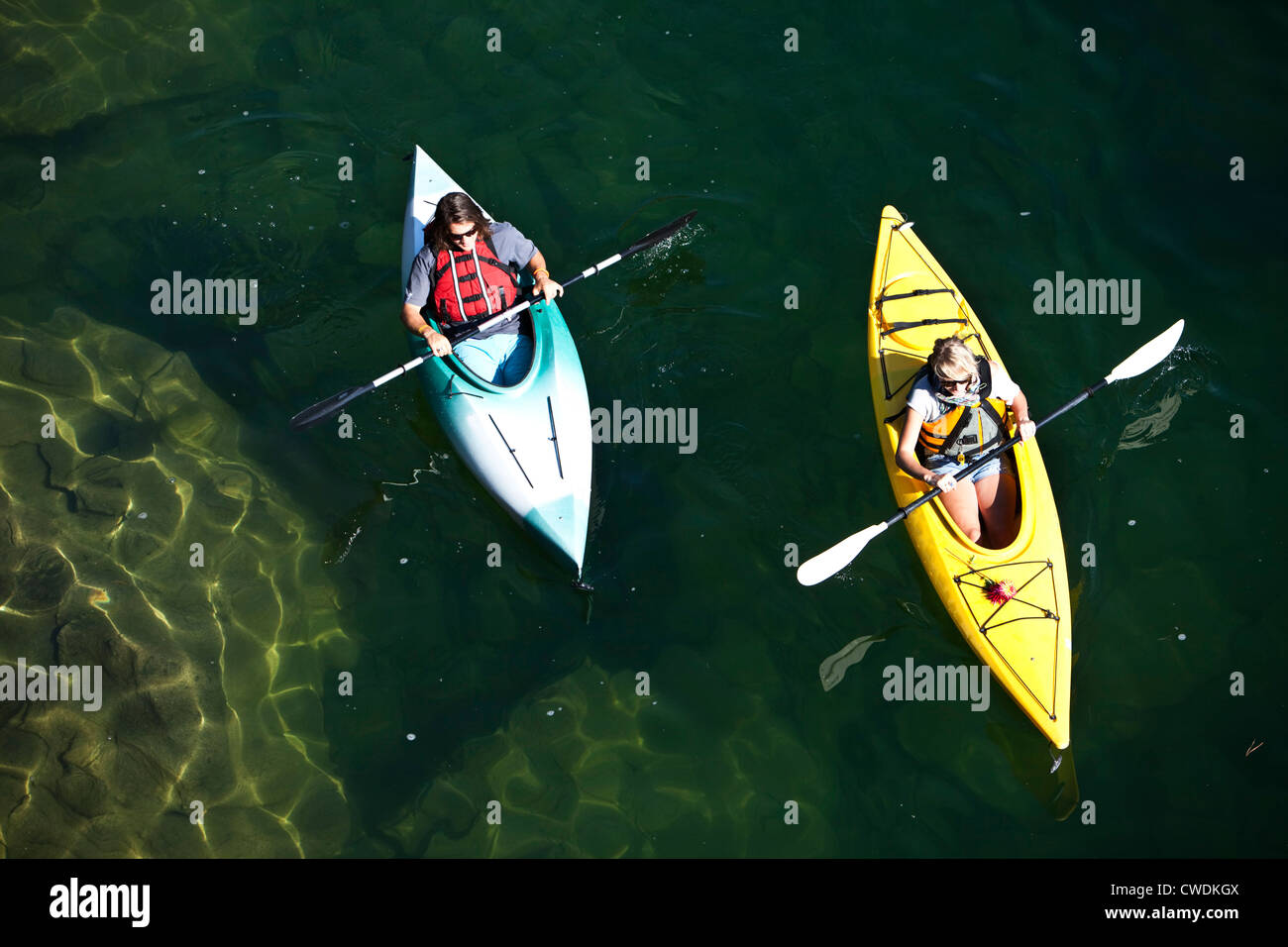 A young adult couple kayaking on a sunny day on a lake in Idaho. Stock Photo