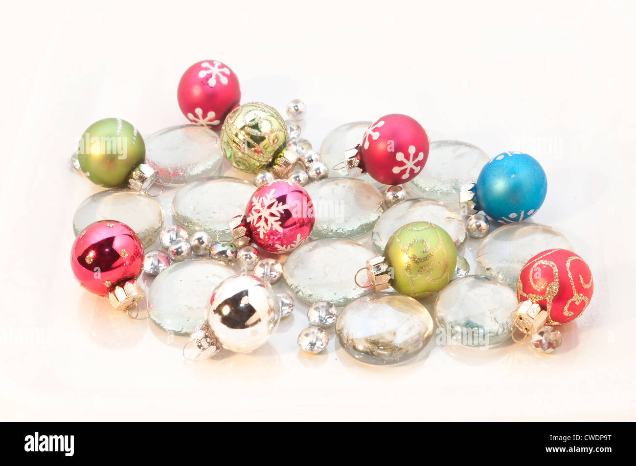 Old-fashioned Christmas decorations sparkle atop an icy background. Stock Photo