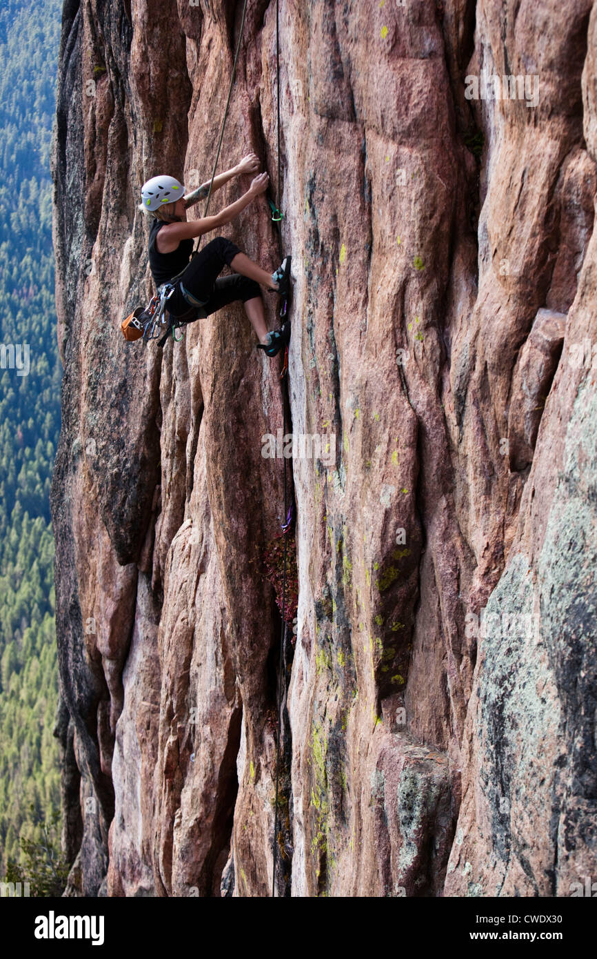 A athletic woman rock climbing near Bozeman, Montana. Stock Photo