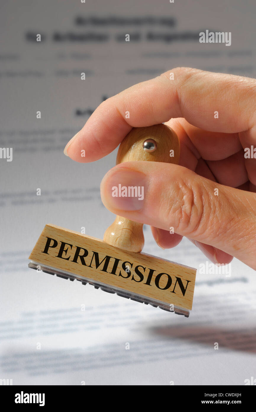 rubber stamp in hand marked with permission Stock Photo Alamy