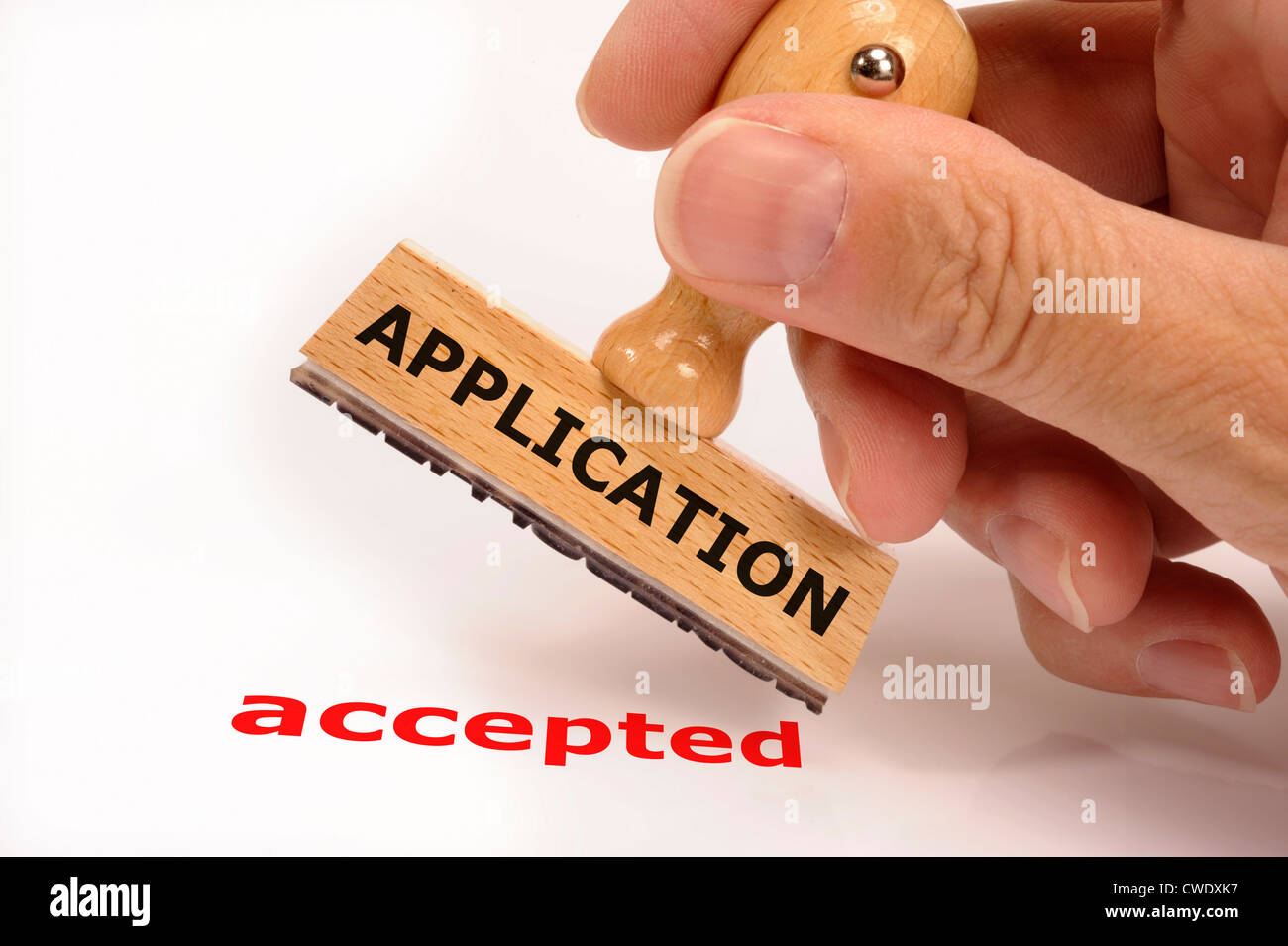 rubber stamp in hand marked with application accepted Stock Photo