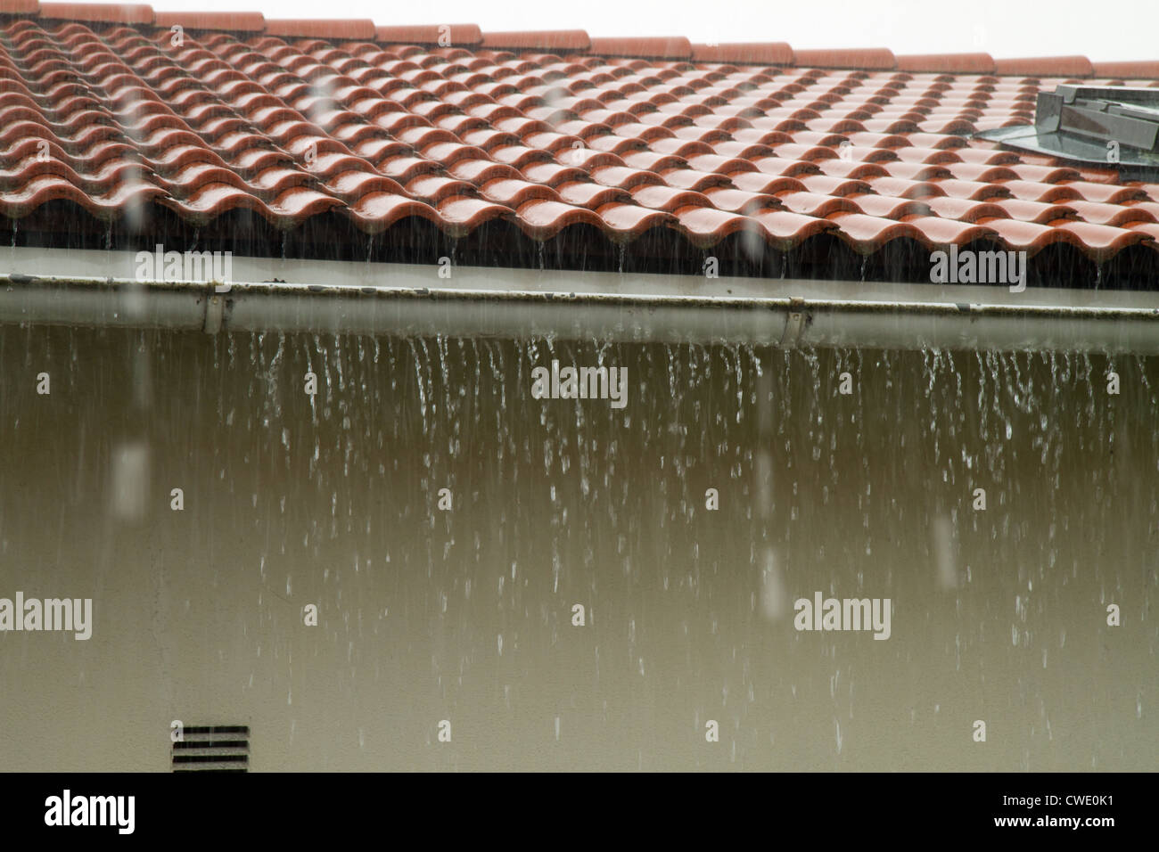 Heavy rain flooding the gutter Stock Photo
