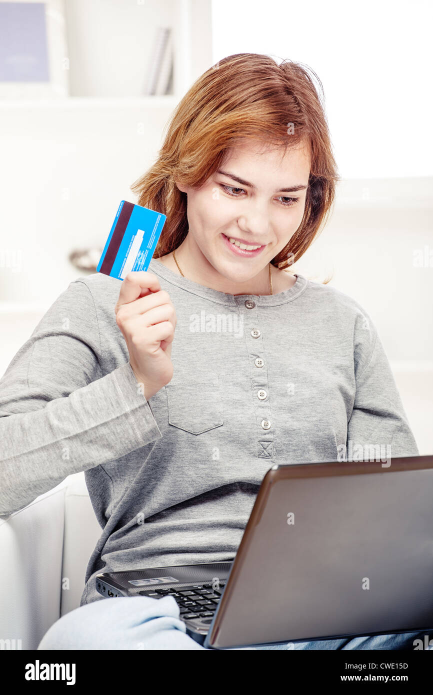 Happy girl doing on line shopping with credit card from home Stock Photo