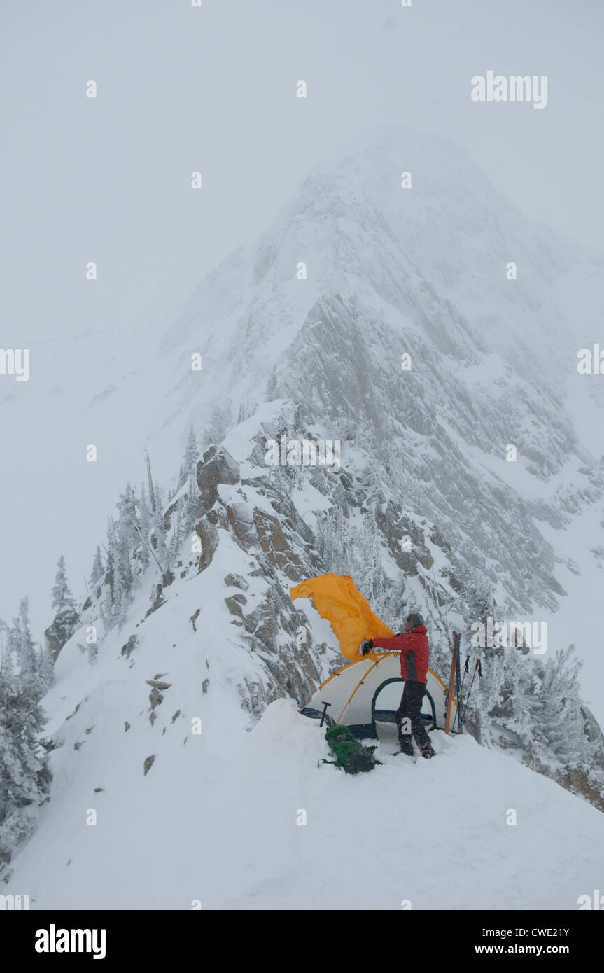 A man pitching a tent below the Pfeifferhorn, Red Pine Canyon, Wasatch National Forest, Salt Lake City, Utah. Stock Photo