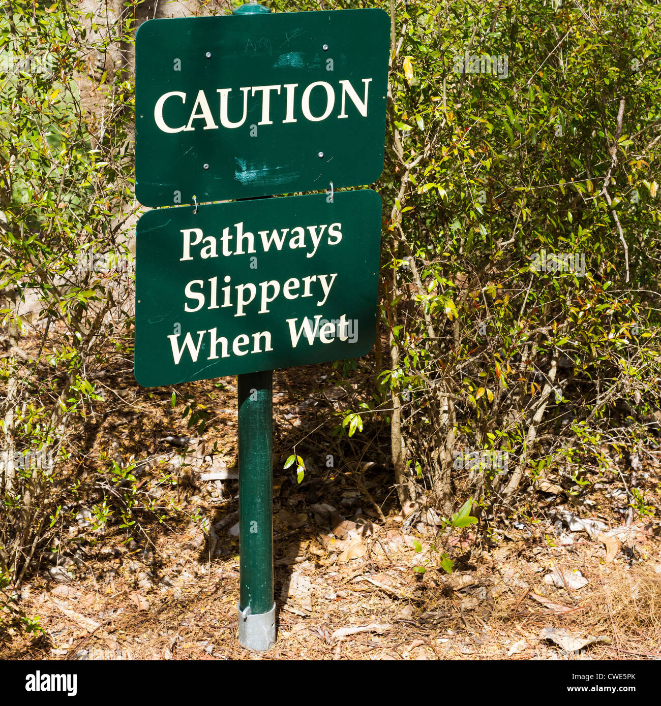 Green pathway sign. Caution Pathways, Slippery When Wet. Stock Photo