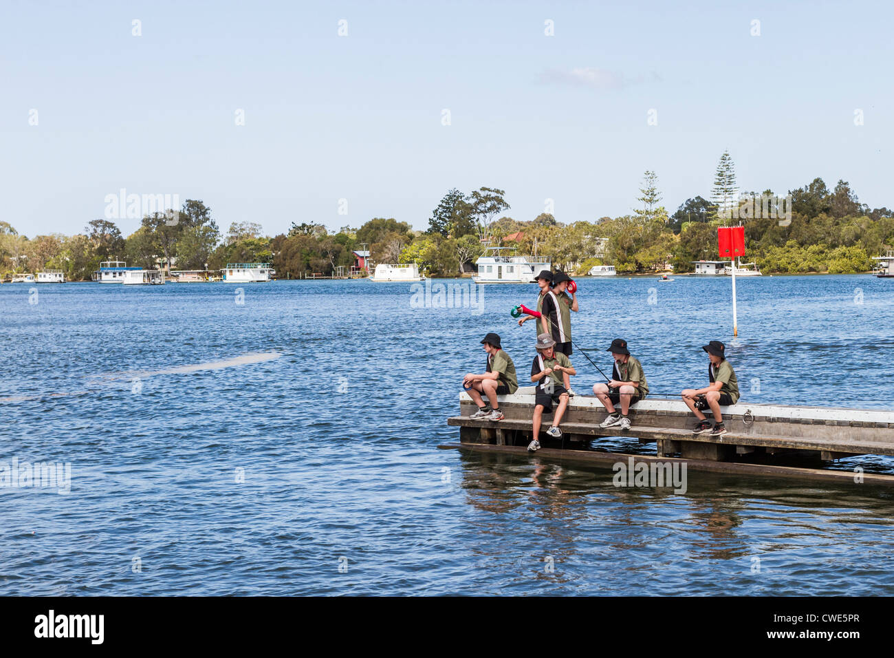 Boys fishing from jetty at Noosa, Sunshine Coast, Australia Stock Photo