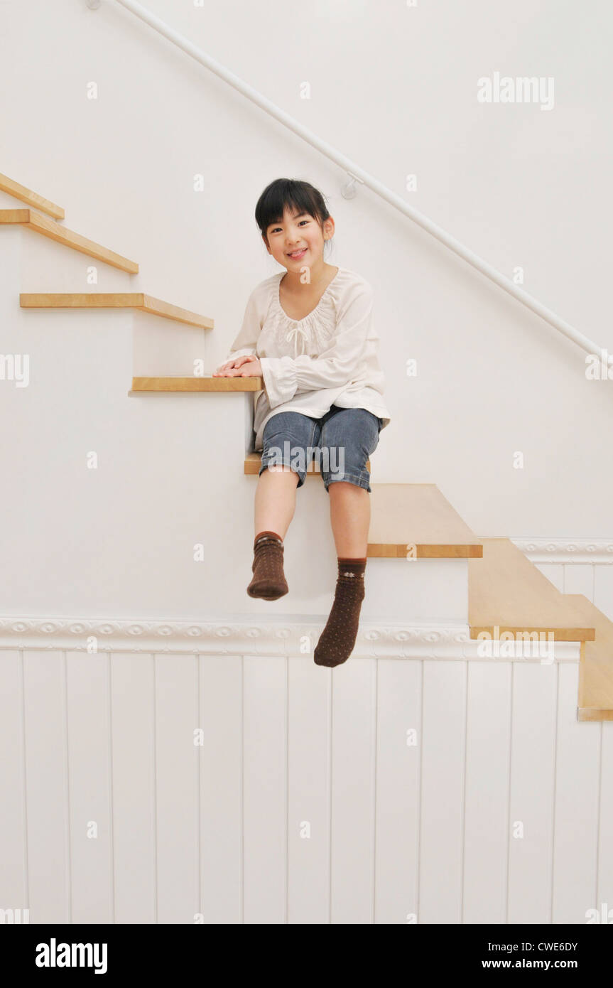 Person sitting on stairs hi-res stock photography and images - Alamy