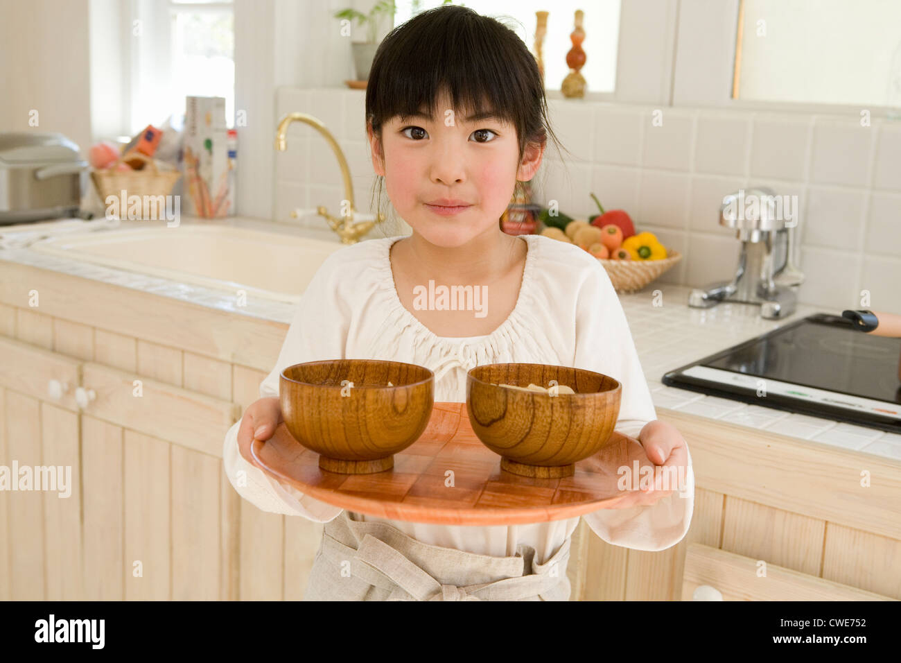 Girl Serving bowls with tray Stock Photo Alamy
