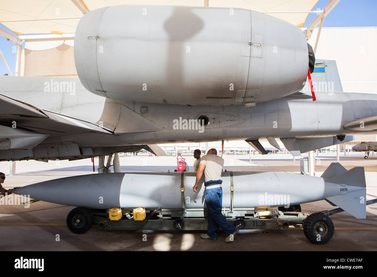 Airmen attach a external fuel tank to an A10 Thunderbolt from the 354th Fighter Squadron at