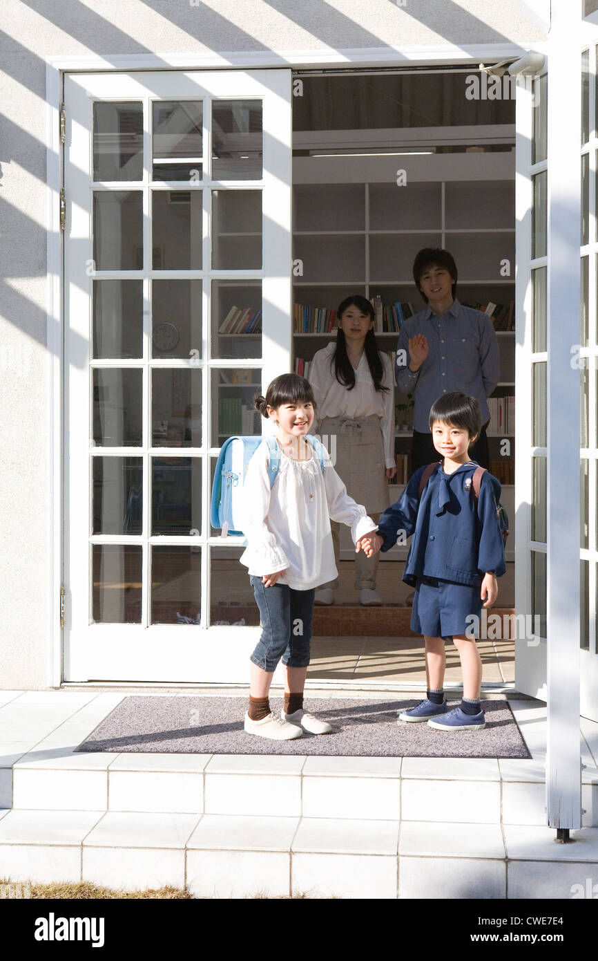Two children standing at entrance Stock Photo Alamy