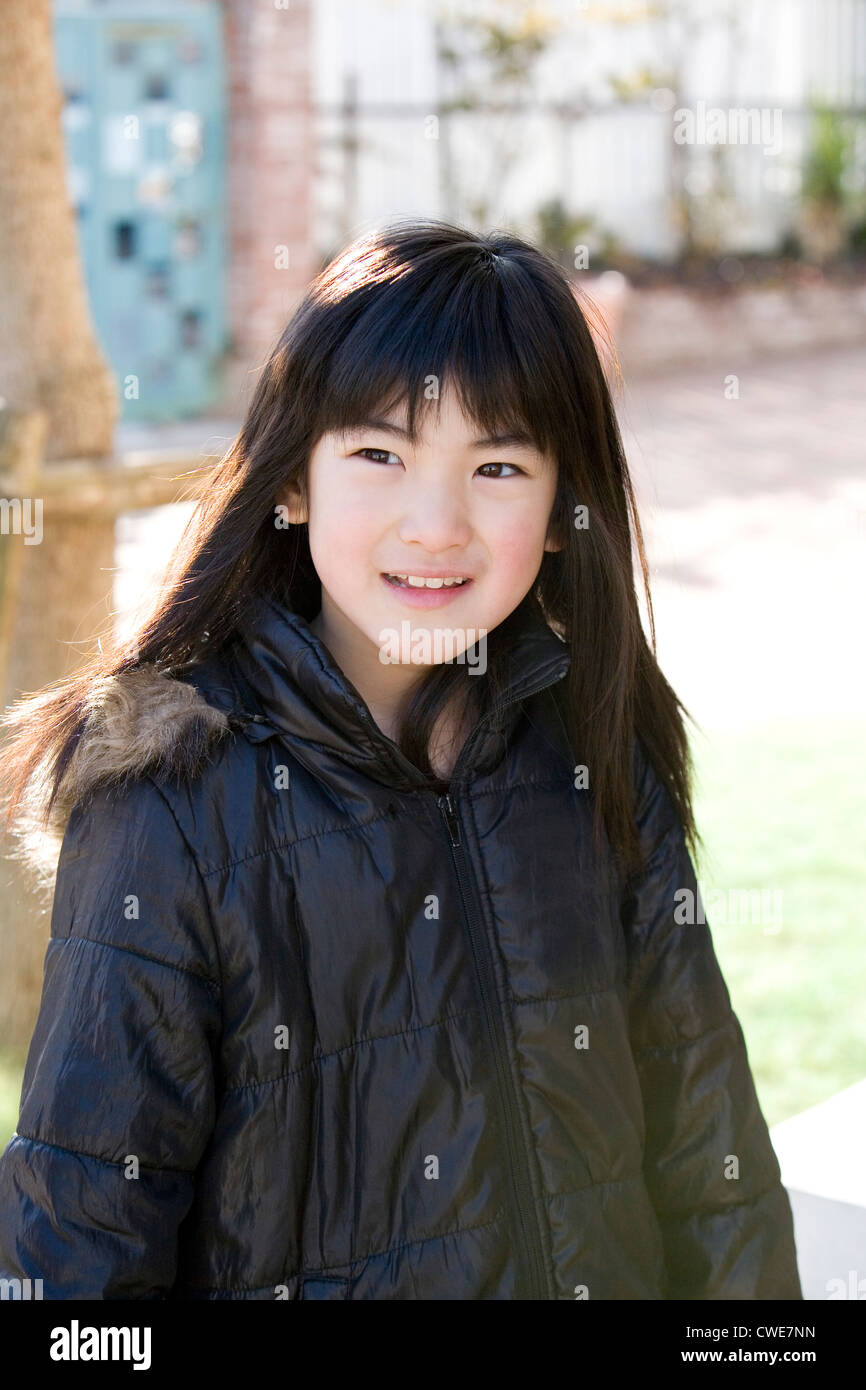 Girl in coat smiling Stock Photo Alamy