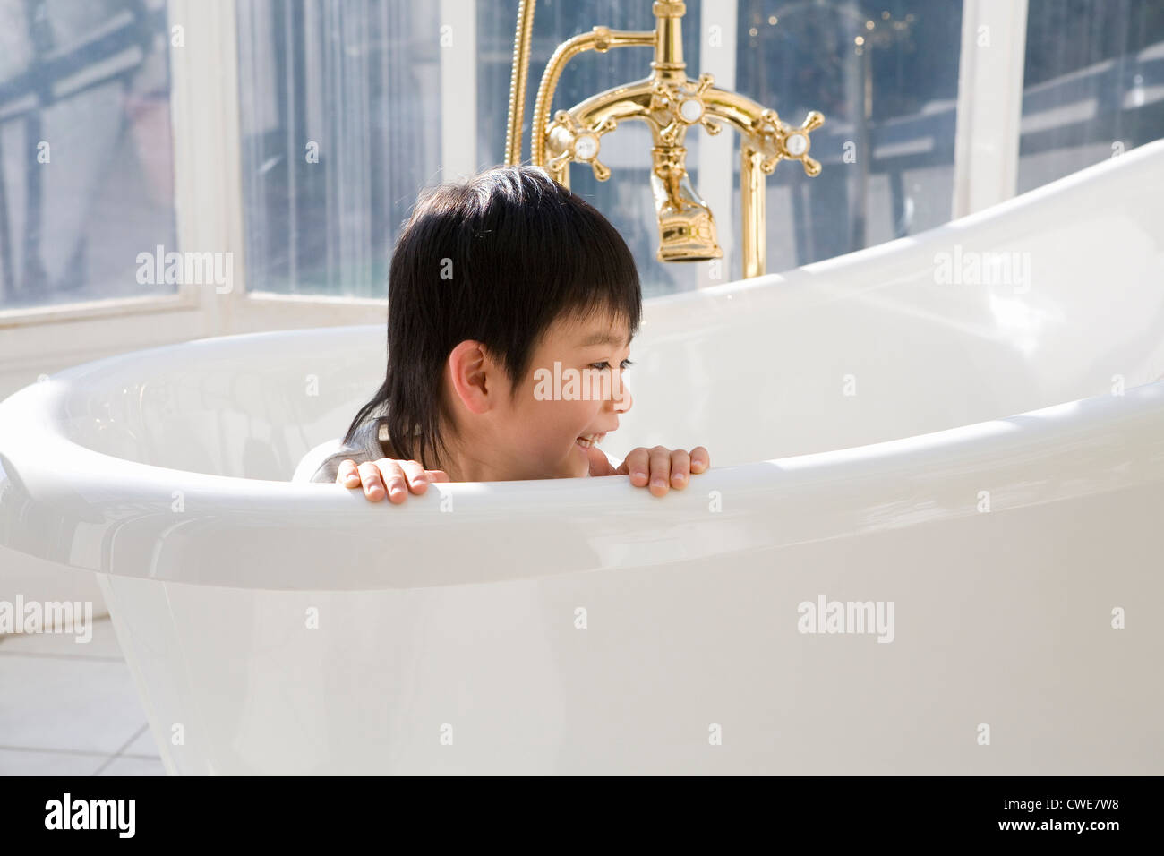 Boy playing in bathtub Stock Photo Alamy