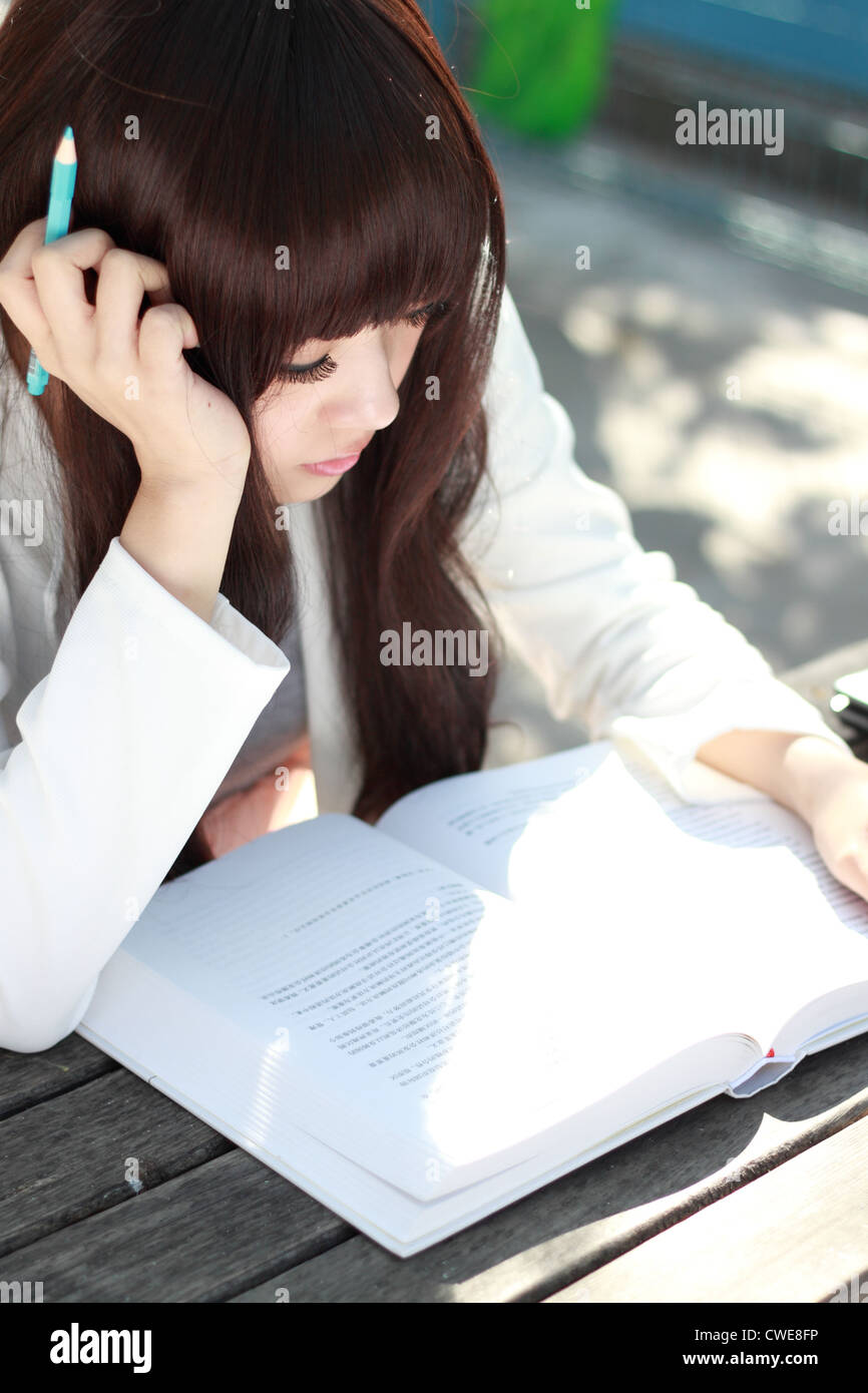 A smiling Asian student is studying. Stock Photo