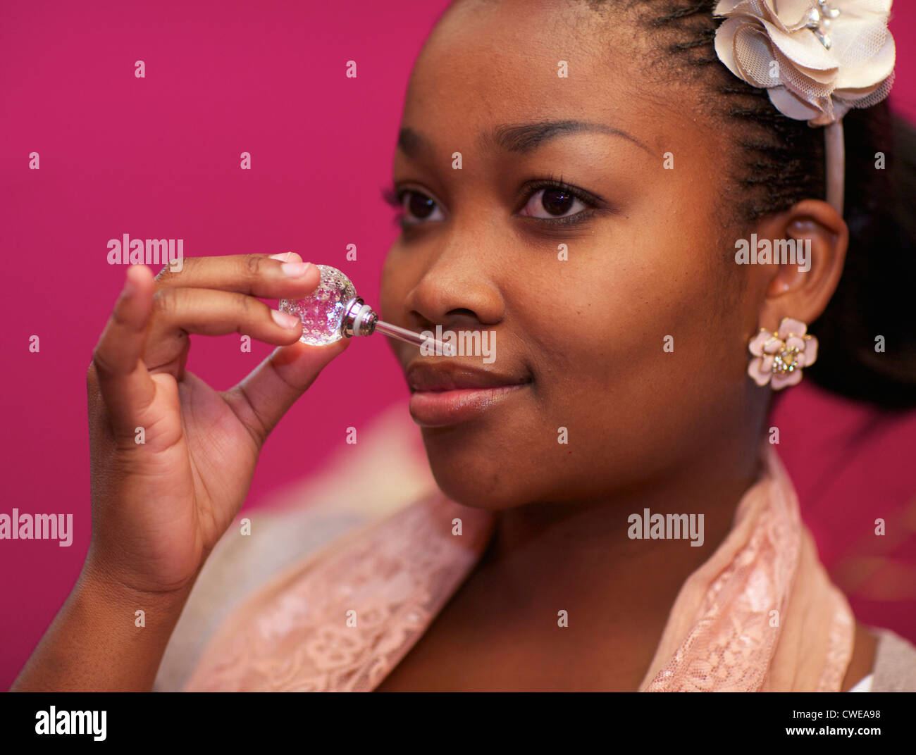 A young woman smelling perfume, Pietermaritzburg, KwaZulu-Natal, South Africa Stock Photo