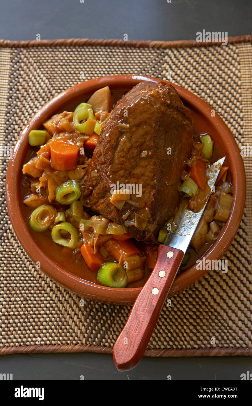 Traditional African cooking. Beef pot roast. Ingredients: beef, potatoes, onions, leeks Stock Photo