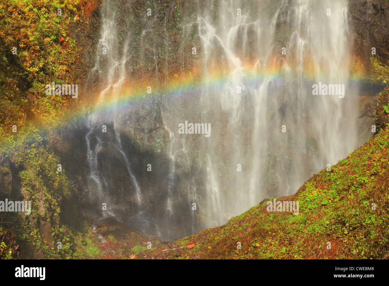 Rainbow And Waterfalls, Moss Covered Rocks Stock Photo