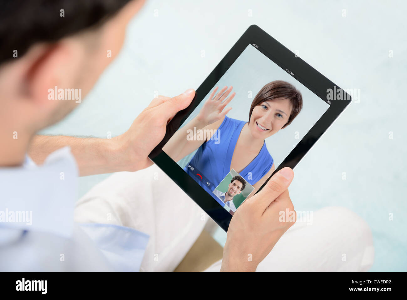 A young couple talking to each other via online video chat. Stock Photo