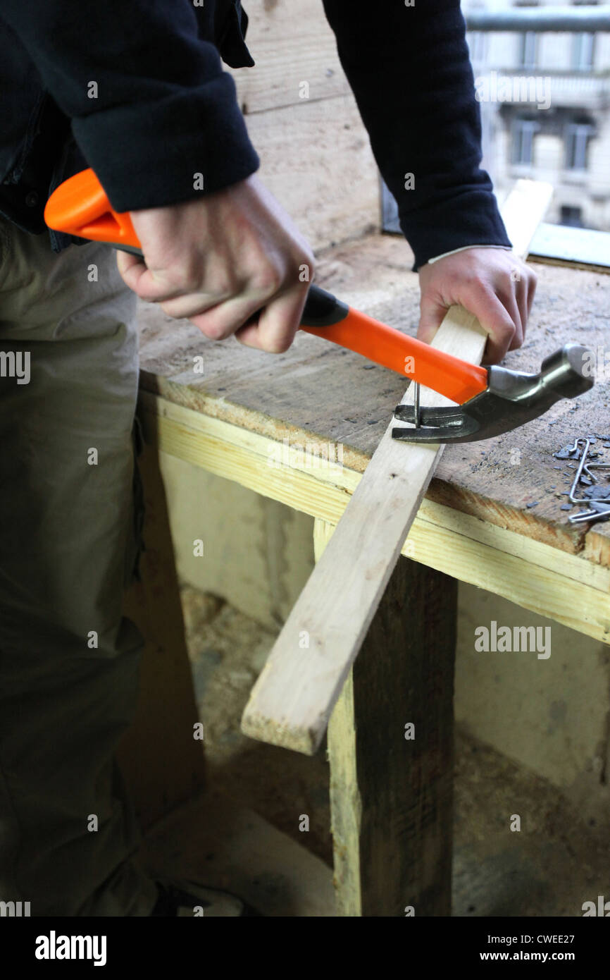 Carpenter removing a nail Stock Photo