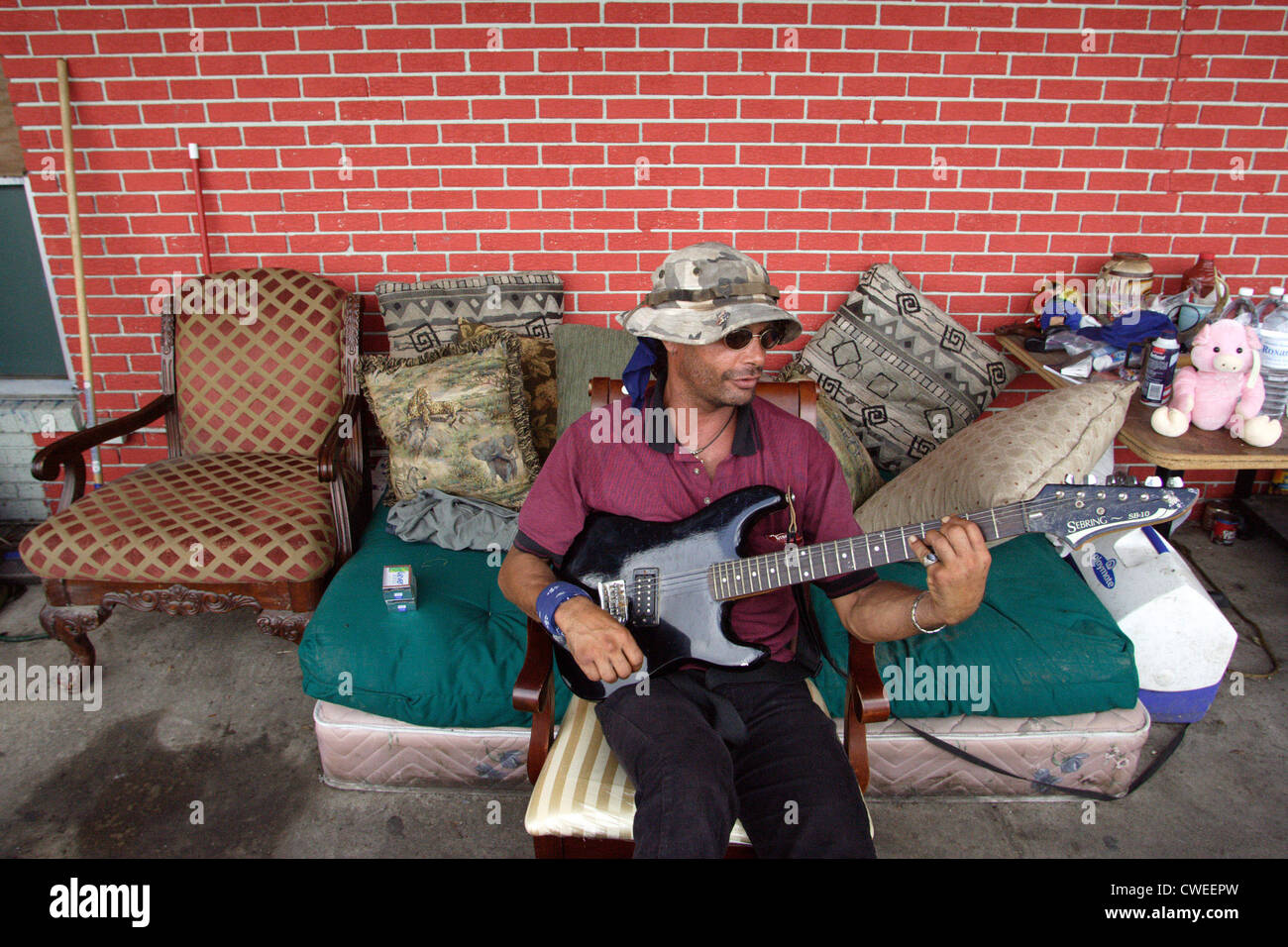 Man playing his electric guitar, after Hurricane Katrina Stock Photo