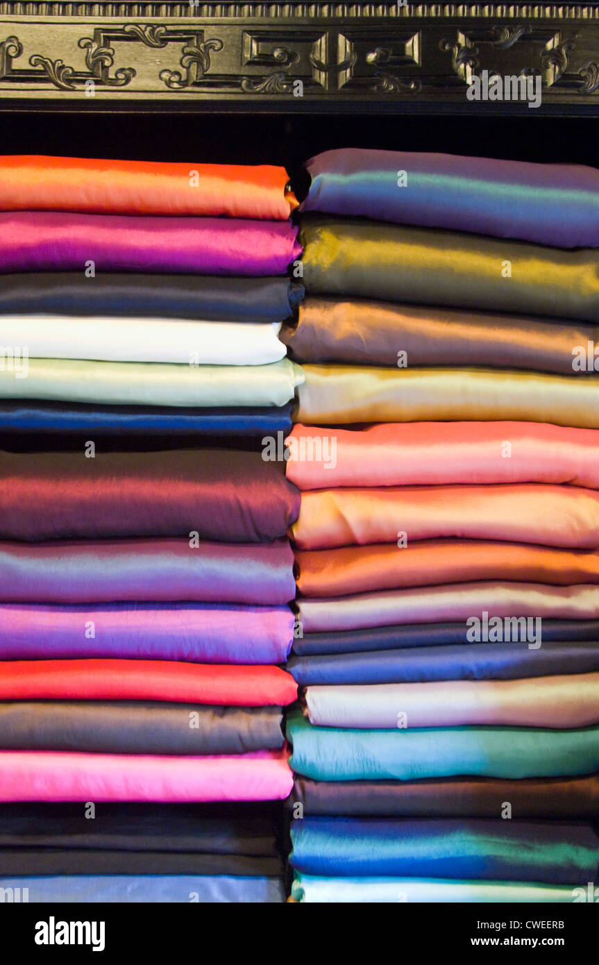 Vertical close up view of lots of different types of colourful silk fabric  on display inside a tailor's shop in Vietnam Stock Photo - Alamy