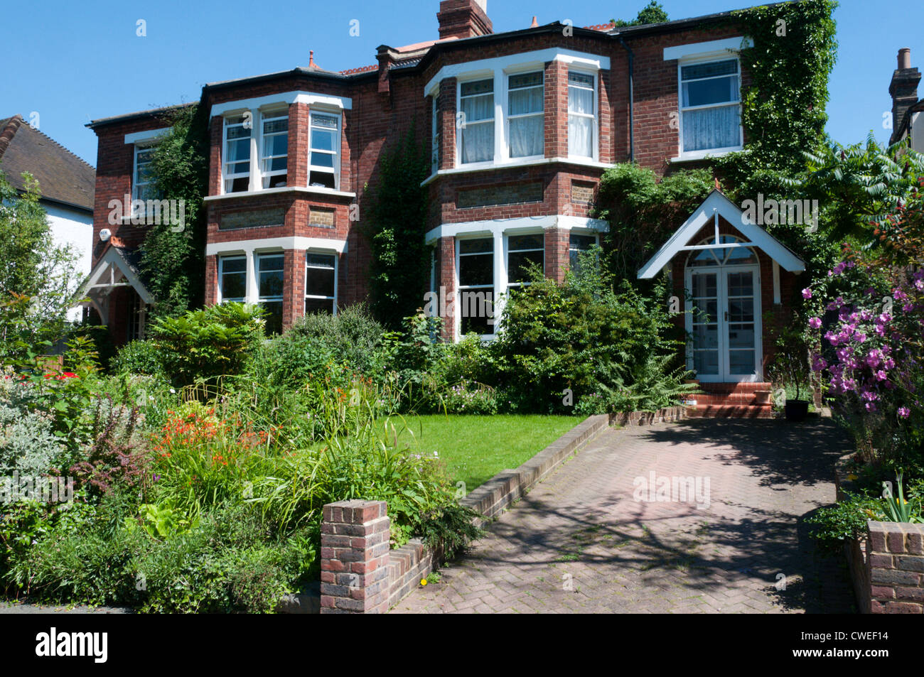 A pair of late-nineteenth century semi-detached houses in South London with brick paved driveways. Stock Photo