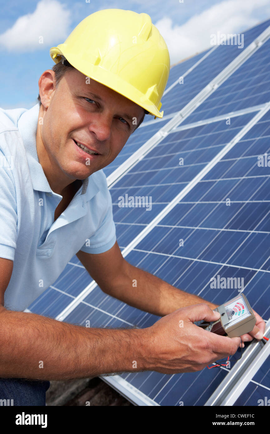 Man installing solar panels Stock Photo