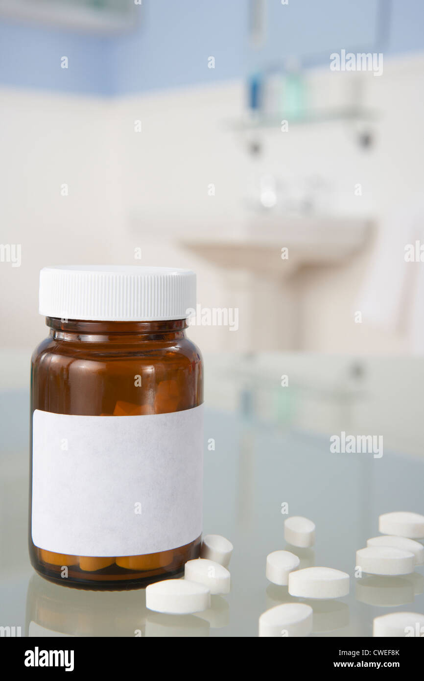 Pills on bathroom shelf Stock Photo
