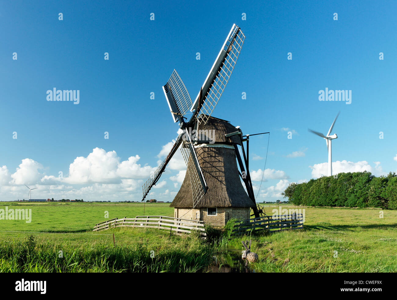 De Snip windmill and wind turbine, near Workum, Friesland, Netherlands Stock Photo