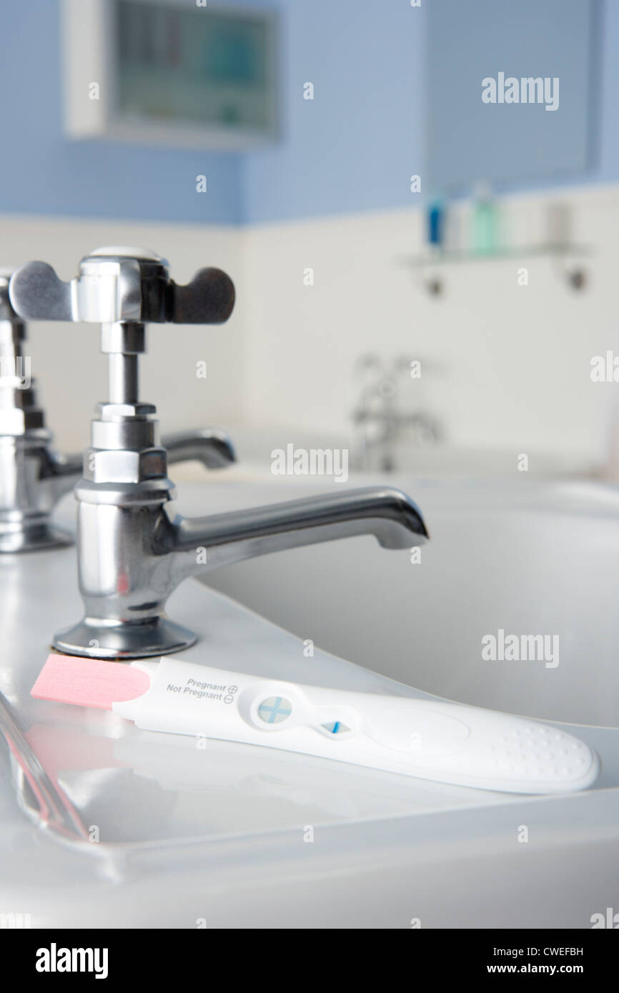 Pregnancy testing kit in bathroom Stock Photo