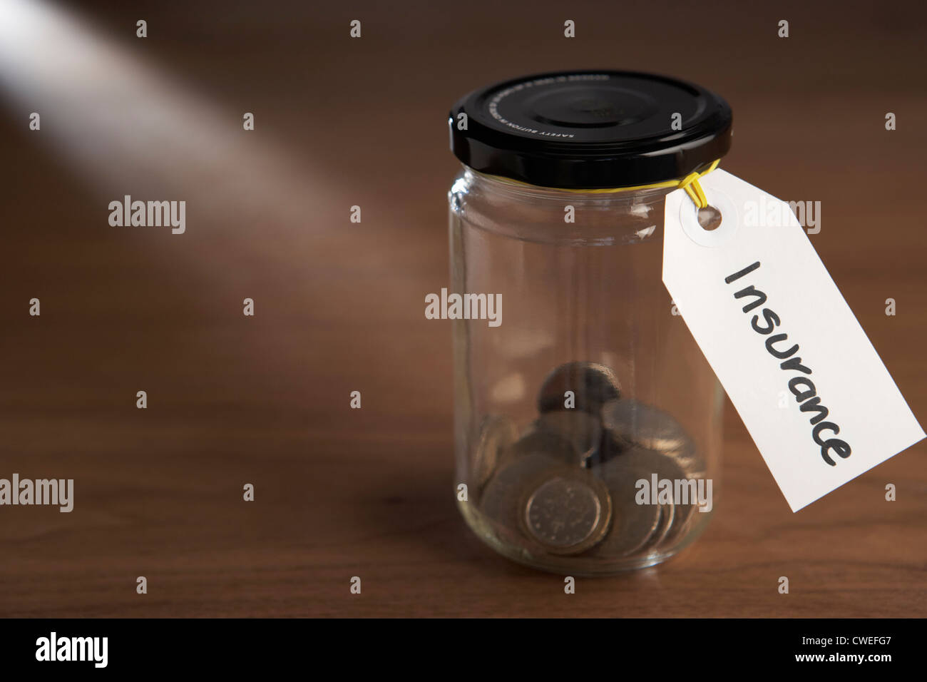 Coins in a jam jar Stock Photo