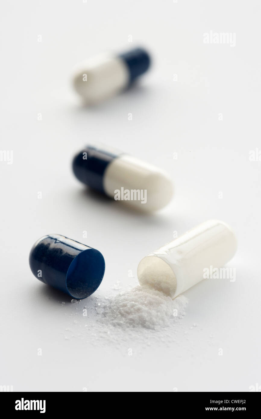 Opened medicinal capsule Stock Photo