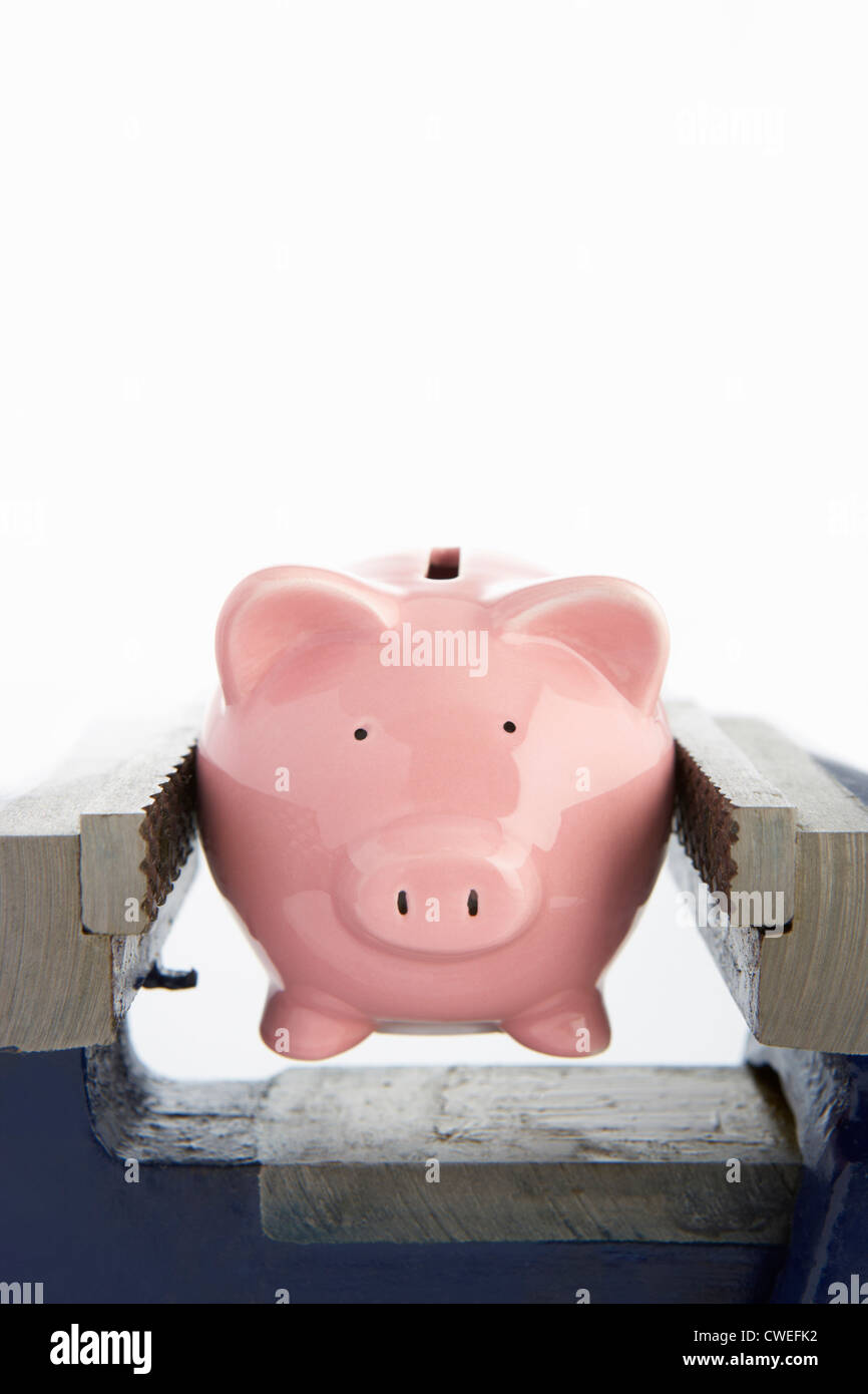 Piggybank in a vice Stock Photo