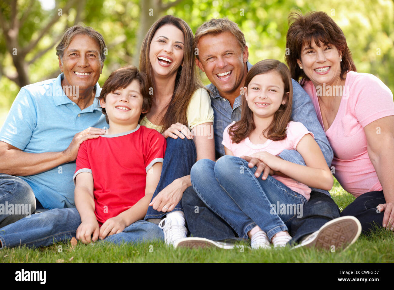 Multi generation Hispanic family in park Stock Photo