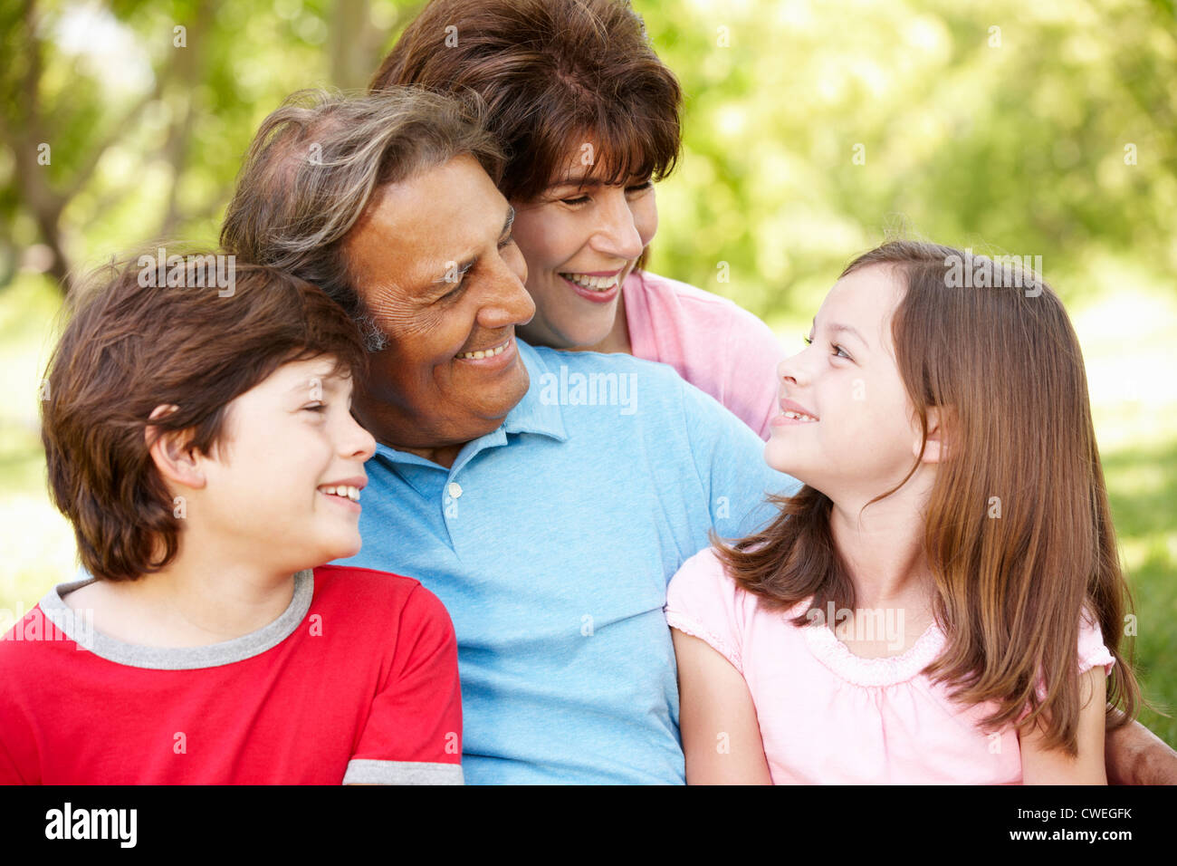 Hispanic grandparents and grandchildren outdoors Stock Photo